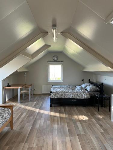 a large room with two beds and a table at B&K het hoenveld in Driel