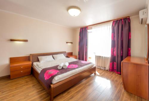 a bedroom with a bed with two shoes on it at Cheap Apartments in Kyiv
