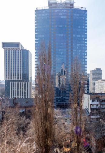 a city skyline with tall buildings in the background at Cheap Apartments in Kyiv