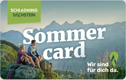 a man and a woman sitting on top of a mountain at Höflehner Premium Eco Lodge in Haus im Ennstal