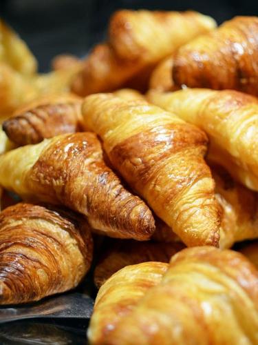 a pile of croissants sitting next to each other at Trois Studios-Cosy centre village in Brouckerque