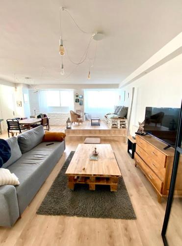 a living room with a couch and a coffee table at Loctudy, les pieds dans l'eau in Loctudy