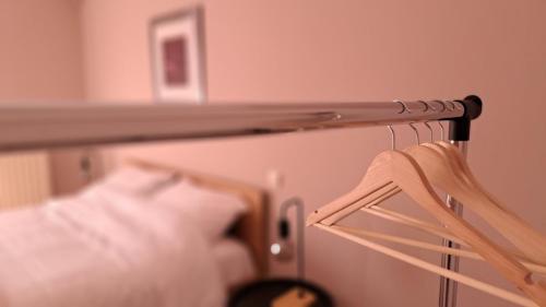 a towel rack next to a bed in a room at Albero in Alexandroupoli