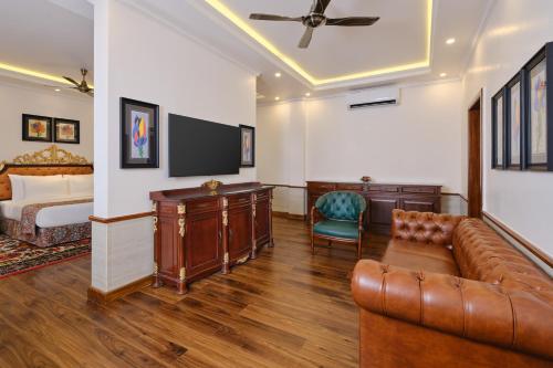 a living room with a couch and a tv and a bed at Mayfair Spa Resort & Casino in Gangtok