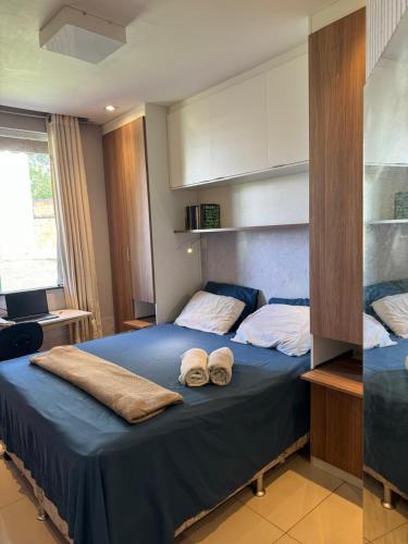 a bedroom with a bed with towels on it at Big house 15 minutes to Belém for 6 people in Ananindeua