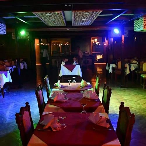 a dining room with a long table and chairs at مركب ريفر بوت River Boat in Cairo
