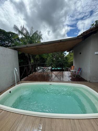 a hot tub on a deck with a table and chairs at Big house 15 minutes to Belém for 6 people in Ananindeua