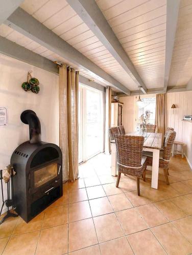 a living room with a fireplace and a table with chairs at Ferienpark Scharmützelsee in Wendisch Rietz