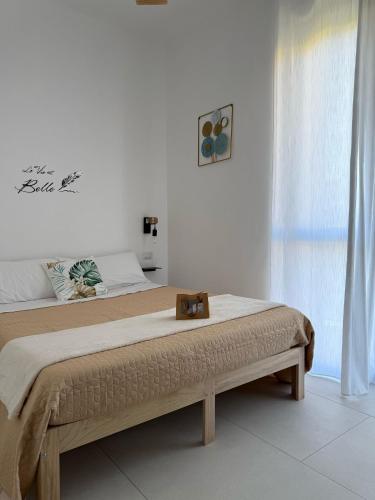 una camera da letto con un letto grande con struttura in legno di Tropical House a Gizzeria