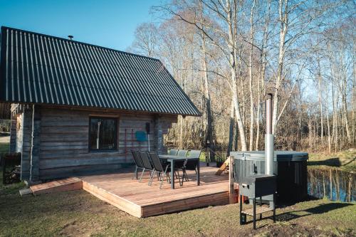 a cabin with a table and chairs on a deck at Paluküla Saunad saunahouse in Paluküla
