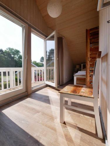 a room with large windows and a desk in a house at Ferienpark Scharmützelsee in Wendisch Rietz