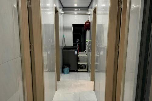 a hallway leading to a bathroom with a mirror at Space Sharing Station in Guiyang