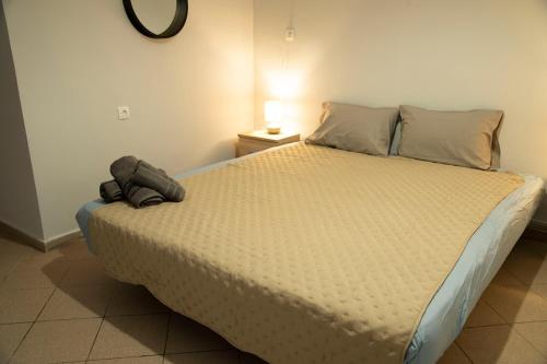 a bedroom with a large bed with a stuffed animal on it at Paradise Tolo Psili Ammos in Tolo