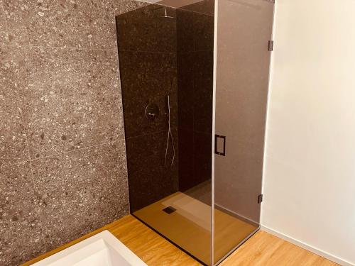 a bathroom with a shower with a mirror at Elegance Rooms Cefalù in Cefalù