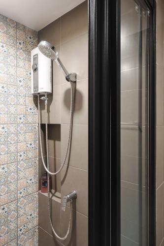 a shower with a shower head in a bathroom at Lacasita Near Beach Huahin (Room21) in Hua Hin