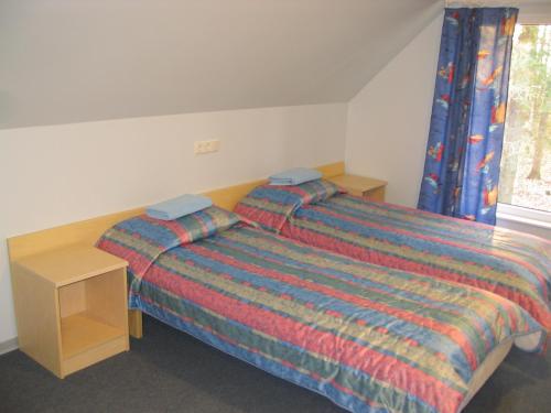 - une chambre avec un lit, une table et une fenêtre dans l'établissement Waide Motel, à Elva