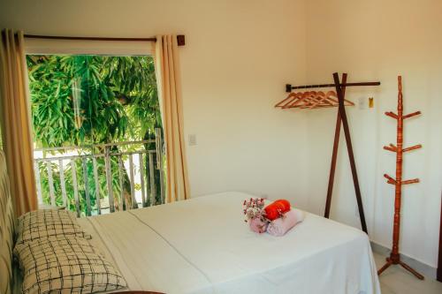 a bedroom with a bed and a large window at Go Pipa INN in Pipa