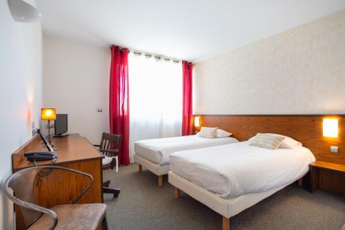 a hotel room with two beds and a desk at Logis Hôtel et Restaurant La Bombardière in Cuq-Toulza