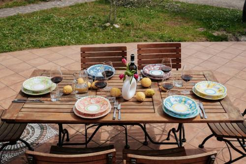 a wooden table with plates and glasses on it at Giulio in Campagnano di Roma