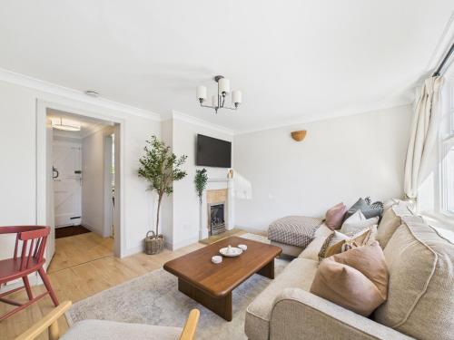 a living room with a couch and a table at Cosy Chester Cottage - Quaint Stay Sleeps 2-5 in Chester