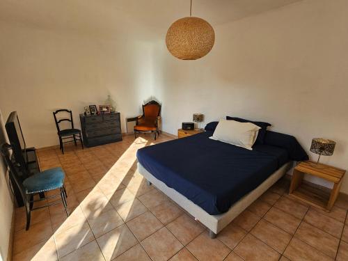 une chambre avec un lit et des chaises dans une pièce dans l'établissement Maison de vacances avec jardin à 500 m de la plage, à Valras-Plage