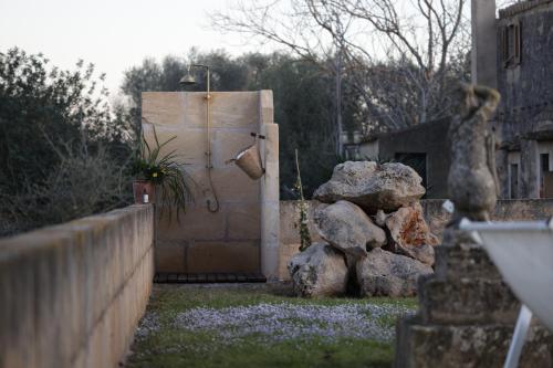 a small refrigerator in a yard with some rocks at Agroturismo Finca Son Pieras in Llucmajor