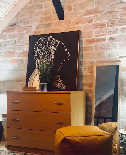 a dresser with a picture on it next to a mirror at My Grandmas School in São João de Areias