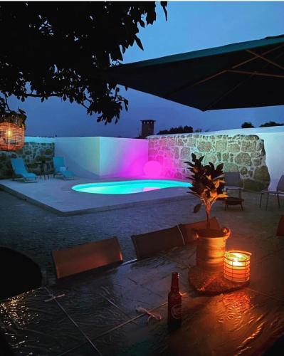 a patio with a table with lights on it at night at My Grandmas School in São João de Areias