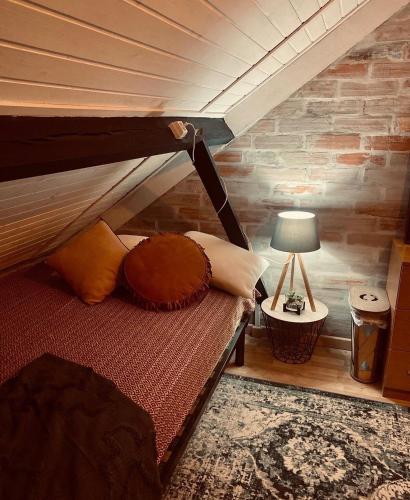 a bedroom with a bunk bed with a brick wall at My Grandmas School in São João de Areias