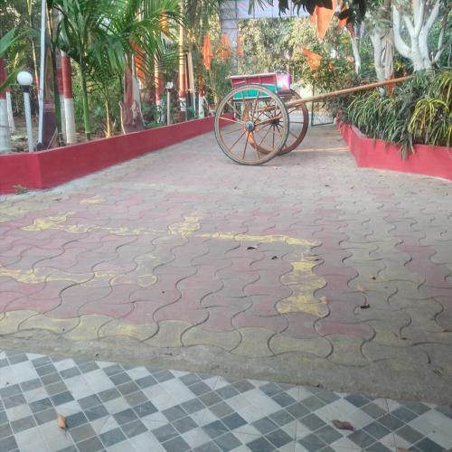 a cart parked on a street with a cobblestone street at Green heaven homestay in Alibaug