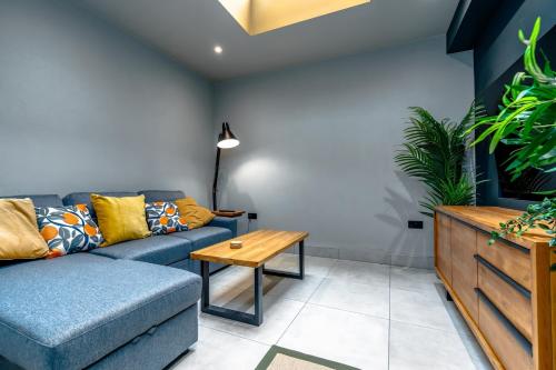 a living room with a couch and a table at Stylish Stokes Croft Apartment, private hot tub in Bristol
