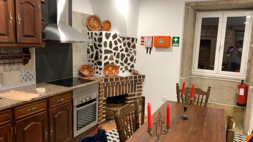 a kitchen with a table and a stove top oven at Albergue Ultreya in Esposende