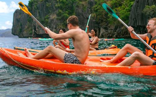 a group of people in a kayak in the water at Mad Monkey Hostel Nacpan Beach in El Nido