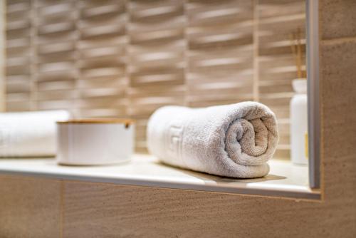 a towel on a shelf in a bathroom at Luma Studio in Dubrovnik