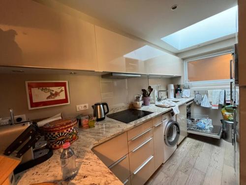 une cuisine avec un évier et une machine à laver dans l'établissement Appartement a la montagne, à Lège-Cap-Ferret