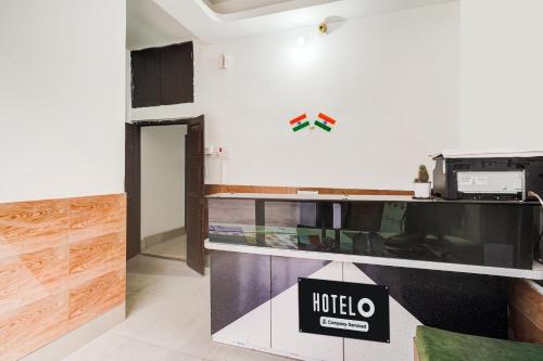 a room with a hotel sign on the wall at Super Hotel O Pradhan Nagar Siliguri Formerly Prince Guest House in Siliguri