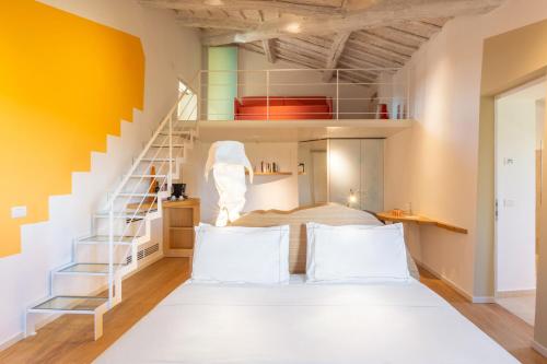 a room with a bed and a staircase at Mastrojanni Relais in Montalcino