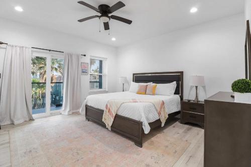 una camera da letto con un letto e un ventilatore a soffitto di Immaculate Townhouse w Pool & Balcony South Padre a South Padre Island