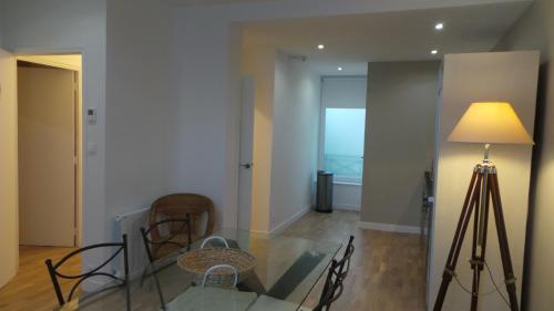a dining room with a glass table and a lamp at 20 rue Gasté, proche gare SNCF de BREST in Brest