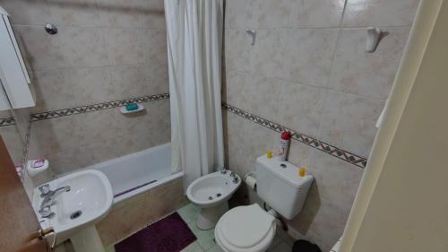 a small bathroom with a toilet and a sink at Departamento Costa Del Sol - 2 dormitorios in Neuquén