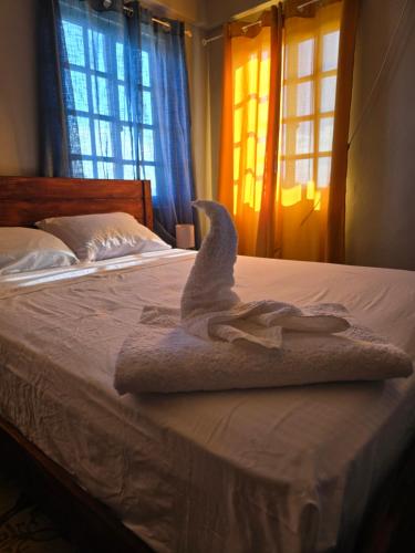 a towel animal is sitting on top of a bed at The Seaview Villa in Charlestown