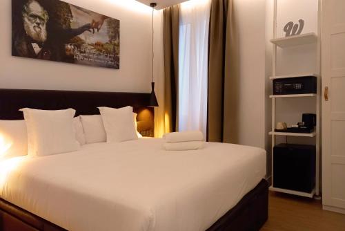 a bedroom with a large white bed in a room at Woohoo Rooms Unique Madrid in Madrid