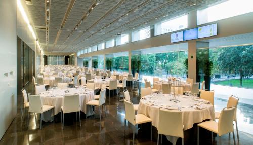 a banquet hall with white tables and chairs at NH Collection Barcelona Constanza in Barcelona