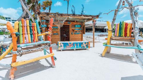 a bunch of surfboards on a rack on a beach at Mangrove Beach Corendon Curacao All-Inclusive Resort, Curio by Hilton in Willemstad