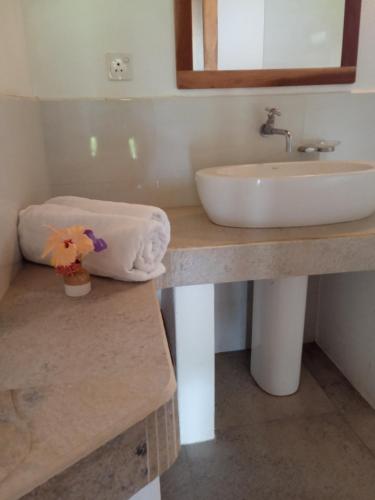 a bathroom with a sink and a towel at Sunshine Cafe in Tangalle