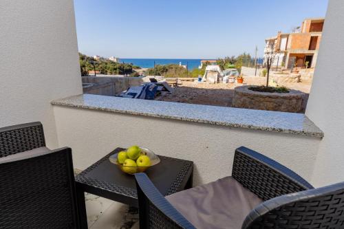 a bowl of fruit on a table on a balcony at Aurora Apartments in Bar