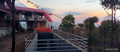 a pool of water in front of a house at Everest Home Stay Temal Kalimati Tower in Thapathali