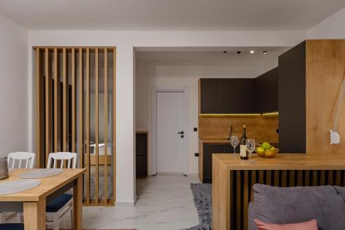 a kitchen and living room with a table and a counter at Aurora Apartments in Bar