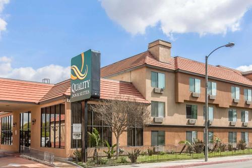 a hotel with a sign in front of a building at Quality Inn & Suites Bell Gardens-Los Angeles in Bell Gardens