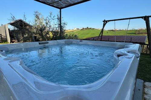 a large plunge pool in a backyard with at Fattoria Cerqua Rooms and more in Montegranaro